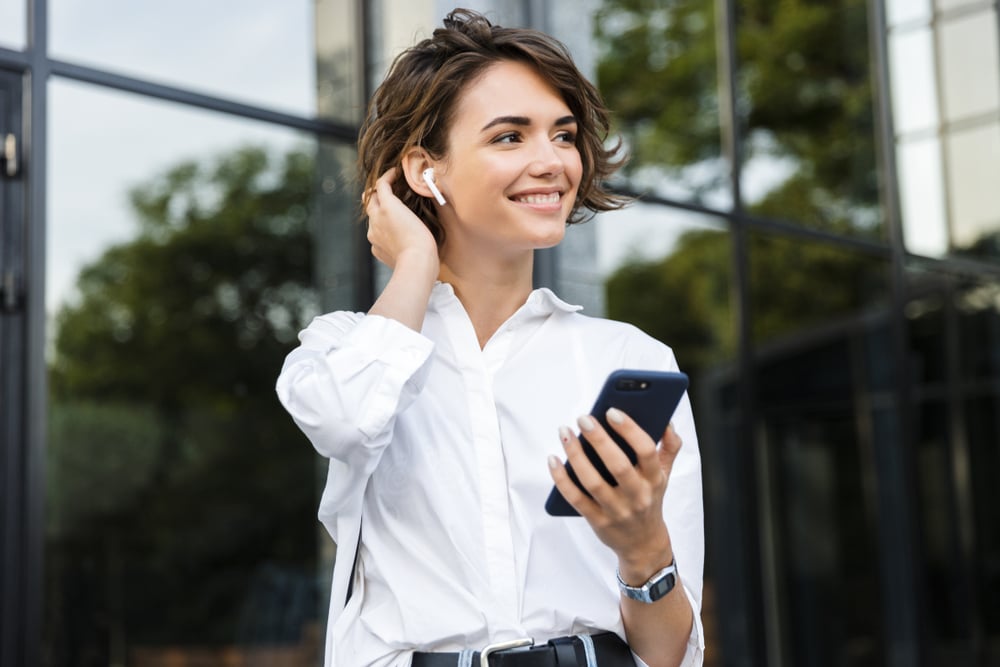 A woman listens to a new podcast episode. 