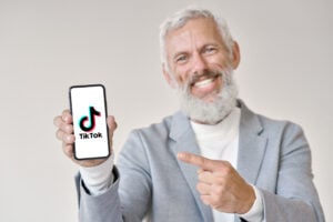 Older business man using Tiktok